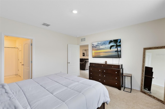 carpeted bedroom featuring ensuite bath