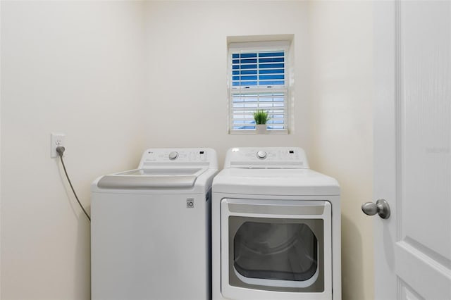 laundry room featuring washing machine and clothes dryer