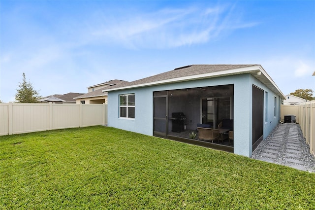 back of house with a lawn, central AC, and a sunroom