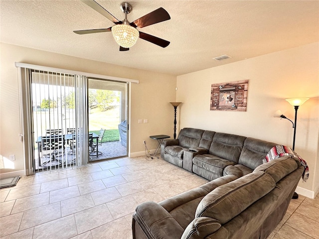 tiled living room featuring a textured ceiling and ceiling fan