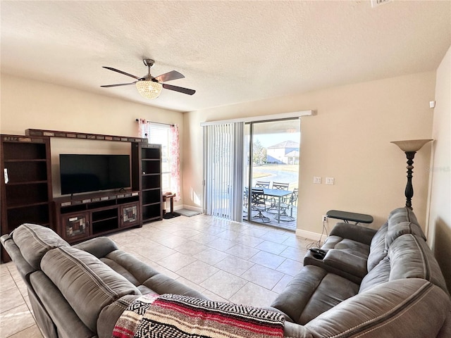 tiled living room with ceiling fan and a textured ceiling