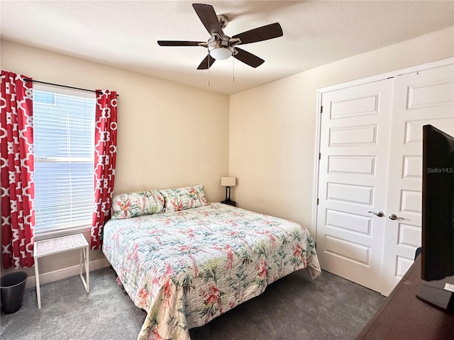 carpeted bedroom featuring ceiling fan, a textured ceiling, and a closet