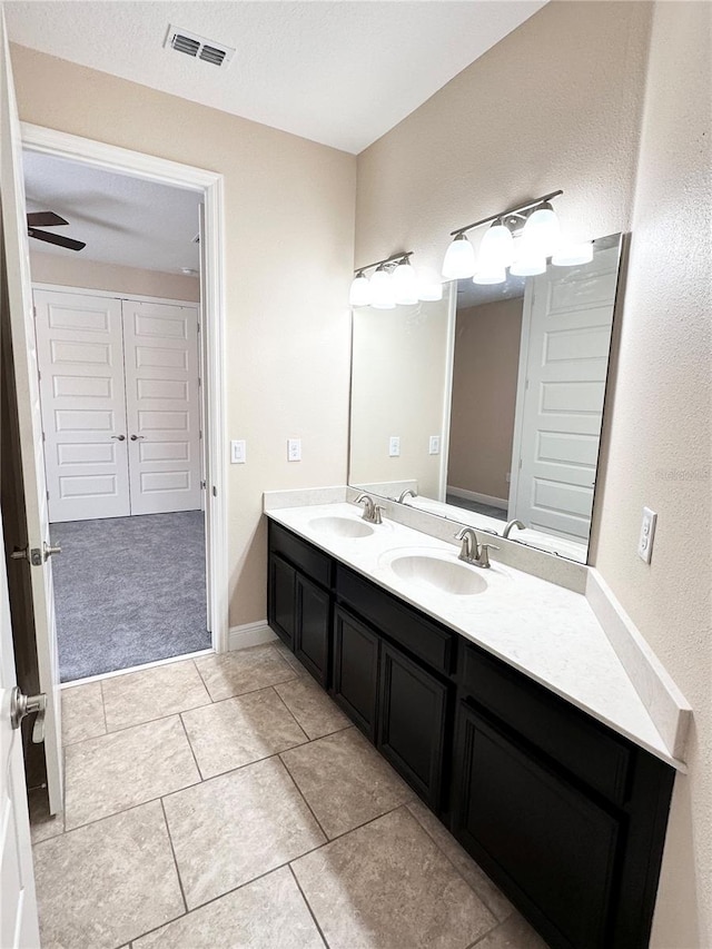 full bath featuring double vanity, visible vents, tile patterned flooring, and a sink