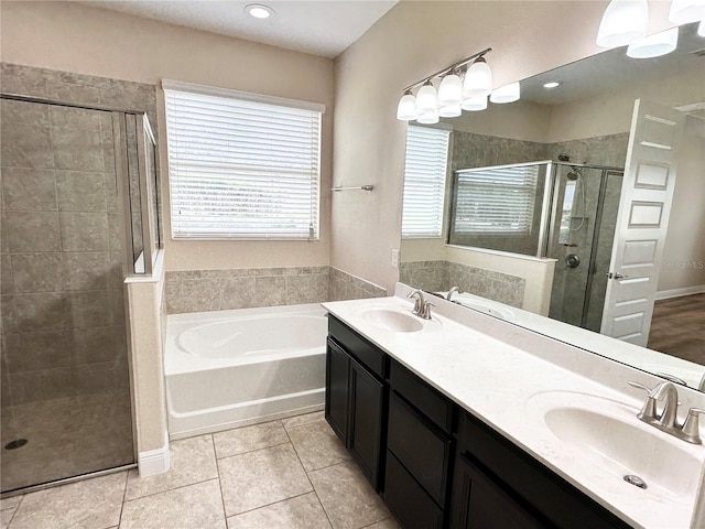 bathroom with a sink, a bath, a shower stall, and tile patterned flooring