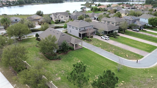 drone / aerial view with a residential view and a water view