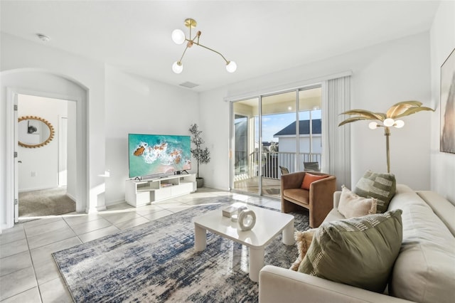 tiled living room with an inviting chandelier