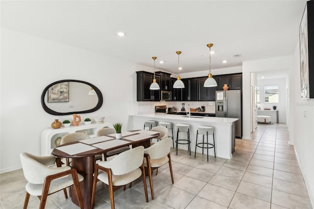 tiled dining space featuring sink