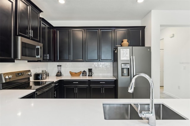 kitchen with decorative backsplash, sink, and appliances with stainless steel finishes