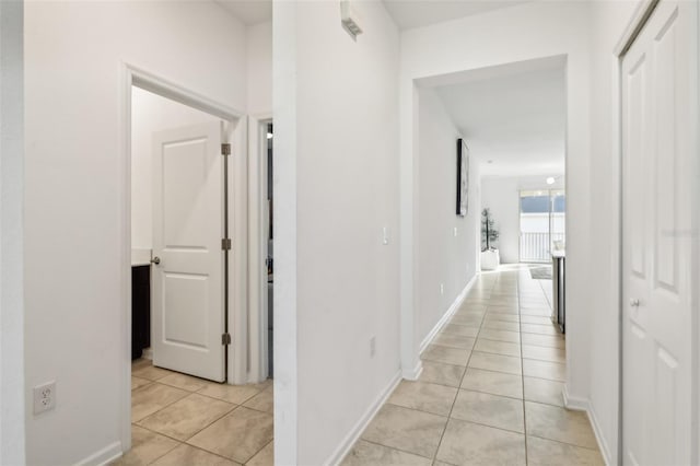 hallway featuring light tile patterned floors