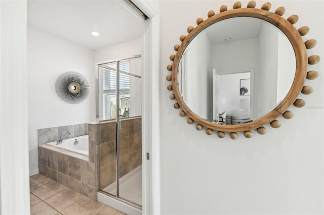 bathroom with shower with separate bathtub and tile patterned floors