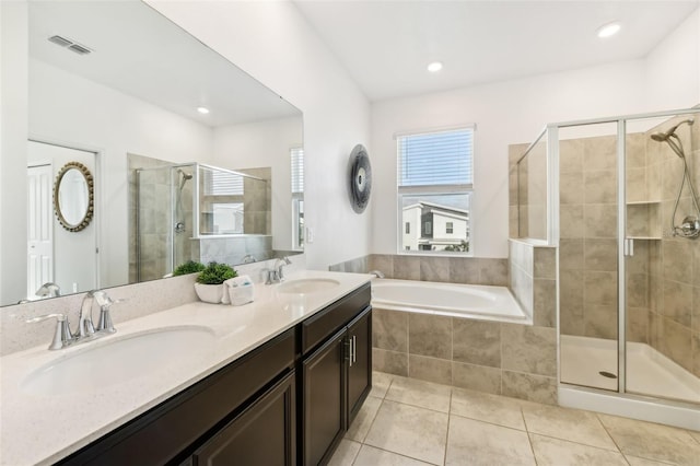 bathroom with tile patterned flooring, shower with separate bathtub, and vanity