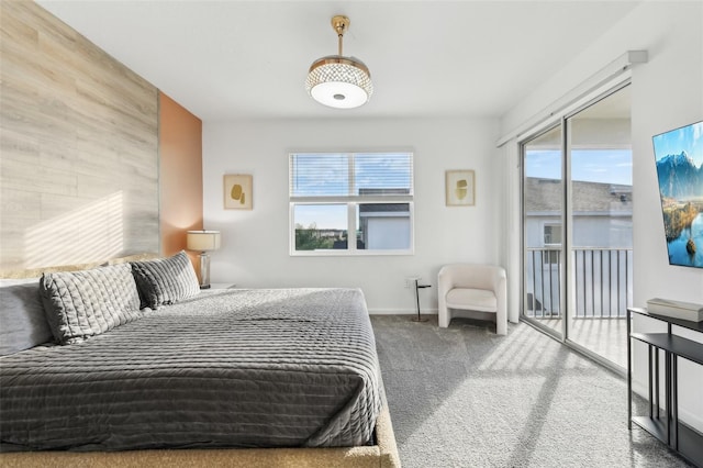 bedroom featuring carpet, access to outside, and wood walls