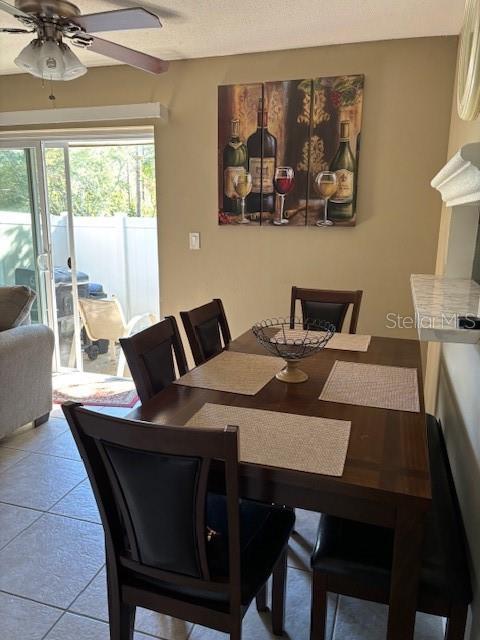 dining room featuring light tile patterned floors and ceiling fan