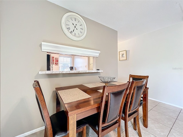 dining area with baseboards and light tile patterned floors