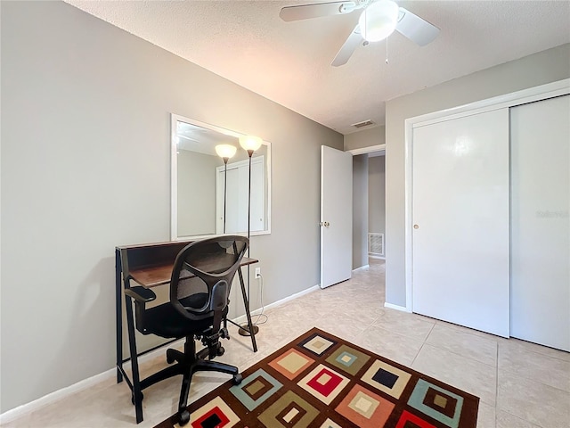 office with ceiling fan, light tile patterned flooring, visible vents, and baseboards