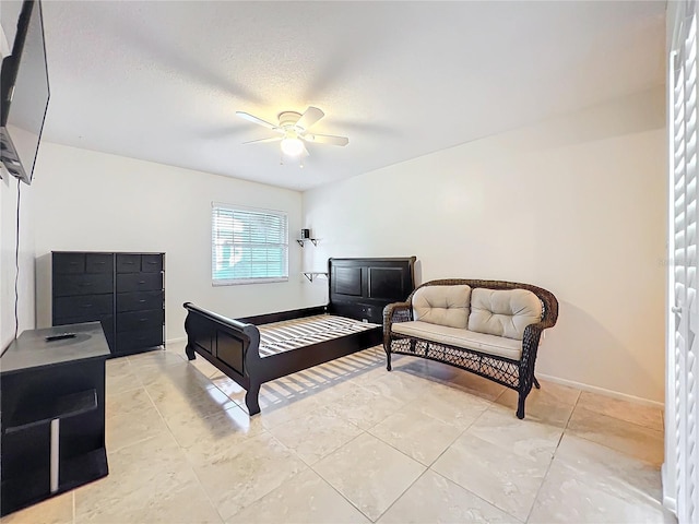 bedroom featuring a ceiling fan, baseboards, and light tile patterned floors