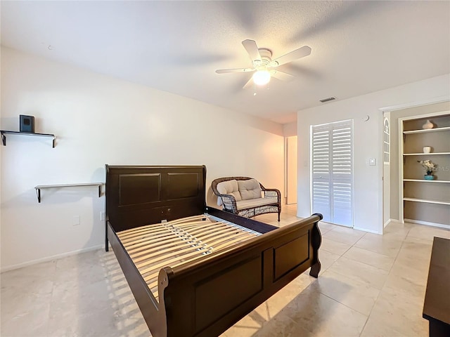 bedroom featuring a ceiling fan, visible vents, and baseboards