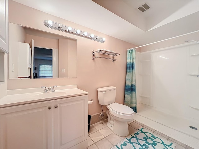 bathroom with a stall shower, visible vents, toilet, tile patterned flooring, and vanity