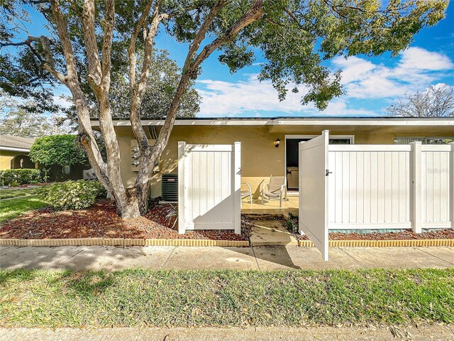 view of front of property with fence and stucco siding