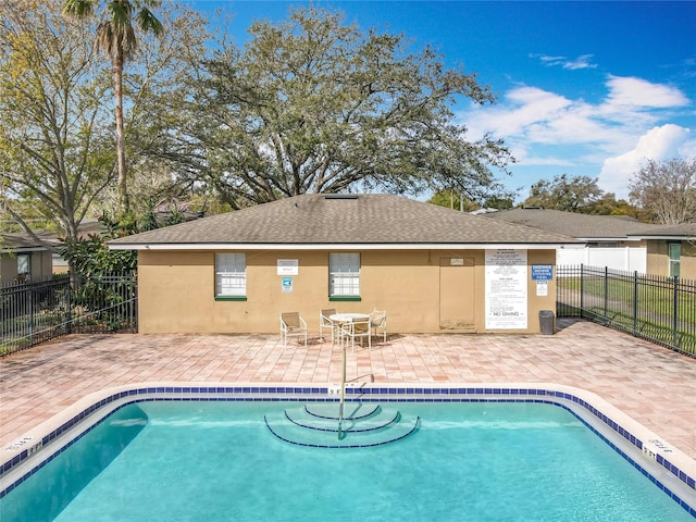 pool with fence and a patio