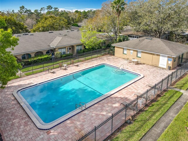 community pool featuring a patio and fence