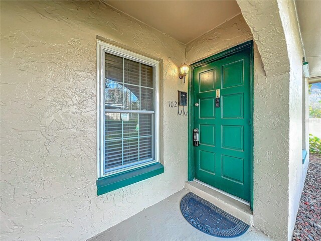 view of exterior entry with stucco siding