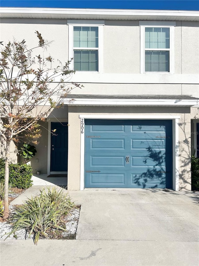 garage featuring concrete driveway