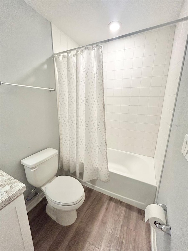 full bath featuring shower / tub combo with curtain, vanity, toilet, and wood finished floors