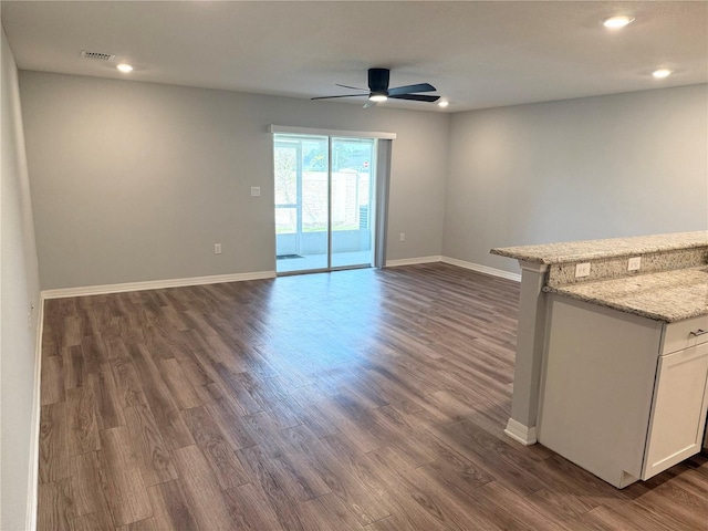 unfurnished living room with dark wood-style floors, baseboards, a ceiling fan, and recessed lighting