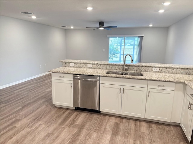 kitchen featuring light wood finished floors, visible vents, white cabinets, stainless steel dishwasher, and a sink