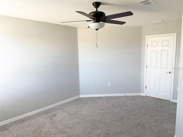 carpeted empty room with baseboards, a textured ceiling, visible vents, and a ceiling fan