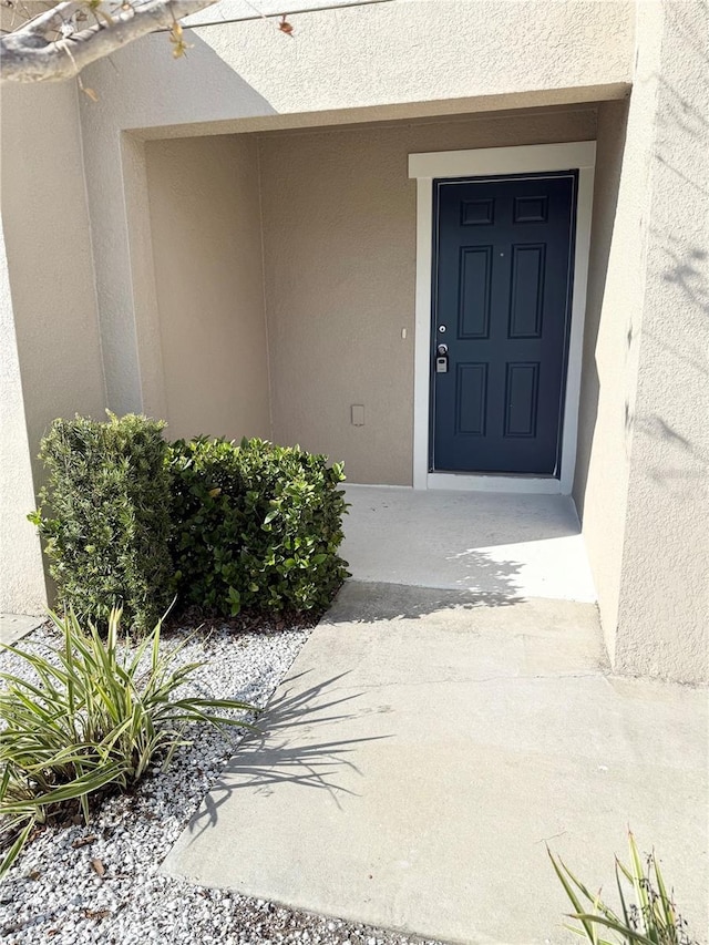 doorway to property with stucco siding