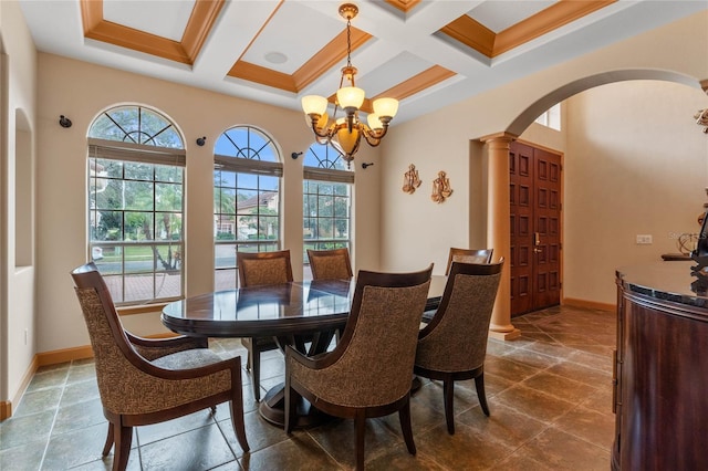 dining area with ornate columns, coffered ceiling, beamed ceiling, crown molding, and a chandelier