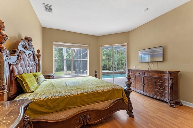 bedroom featuring access to outside and light hardwood / wood-style floors