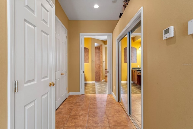 hall featuring light tile patterned floors