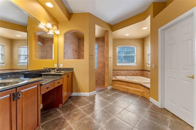 bathroom featuring a wealth of natural light, vanity, and shower with separate bathtub