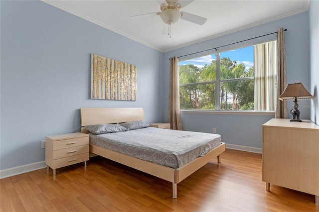 bedroom featuring ceiling fan, light wood-type flooring, and crown molding