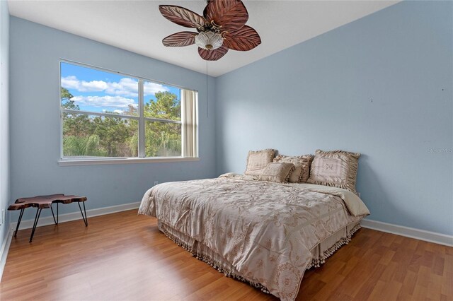 bedroom with light hardwood / wood-style floors and ceiling fan