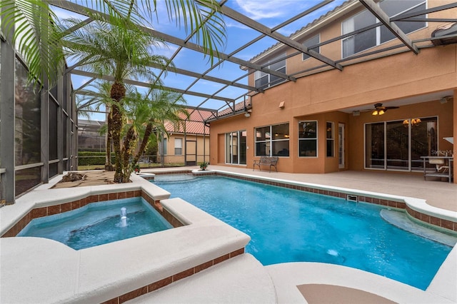 view of pool with ceiling fan, a lanai, an in ground hot tub, and a patio