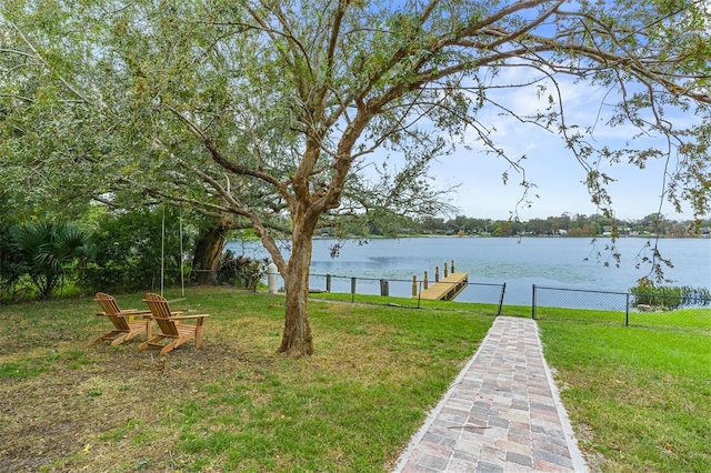 view of yard with a boat dock and a water view