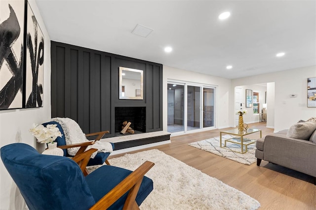 living room with a fireplace and hardwood / wood-style flooring