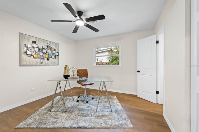 home office with ceiling fan and hardwood / wood-style floors