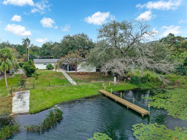 exterior space with a water view and a lawn