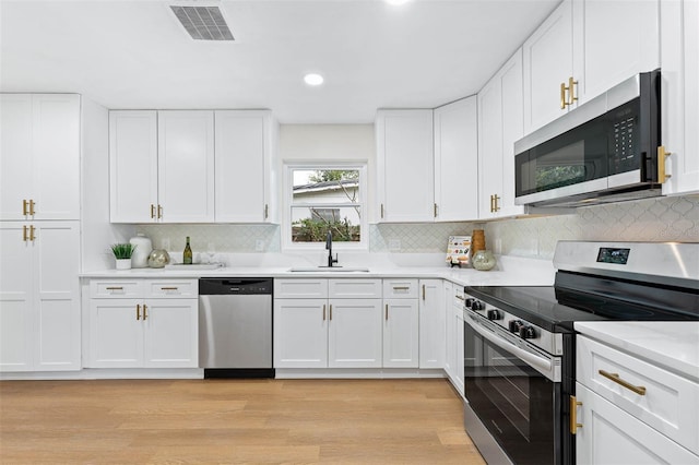 kitchen with white cabinetry, sink, and appliances with stainless steel finishes