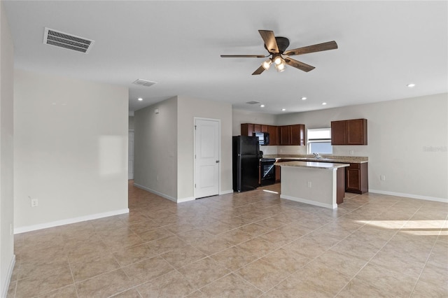 kitchen featuring ceiling fan, sink, black appliances, light tile patterned floors, and a kitchen island