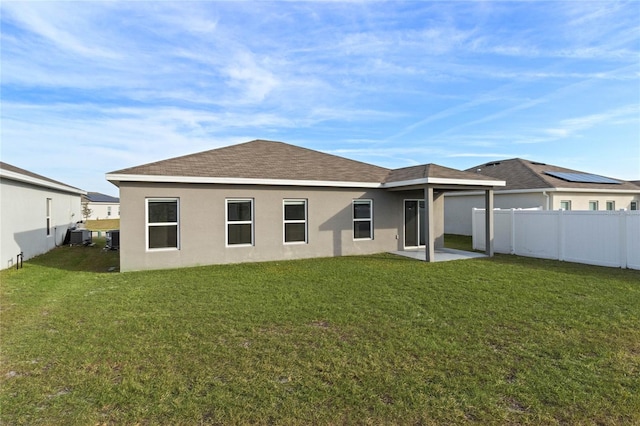 back of house with a lawn, central AC, and a patio