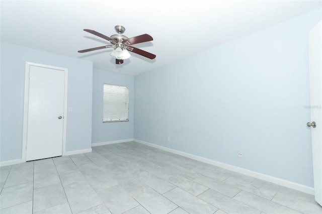 tiled empty room with ceiling fan