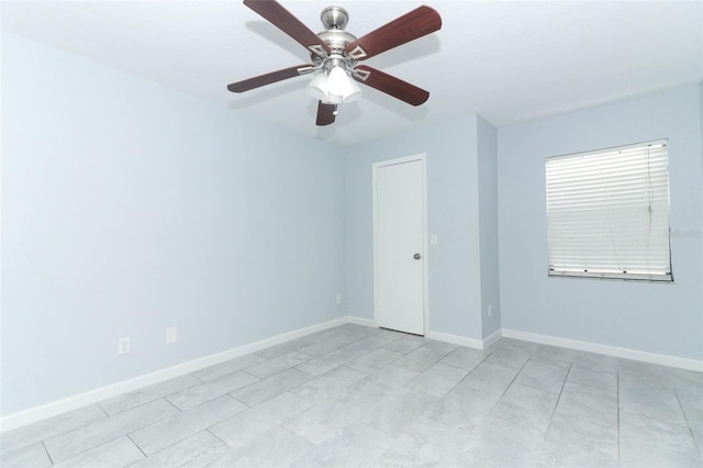 spare room featuring ceiling fan and light tile patterned flooring