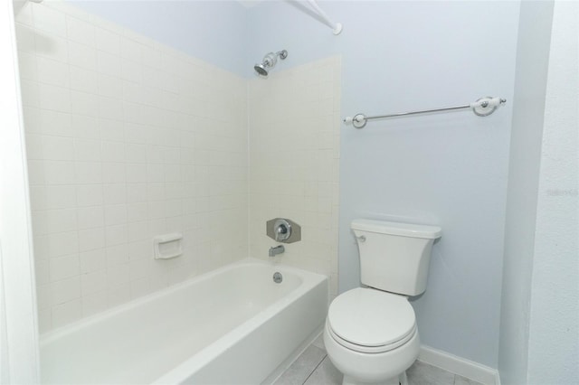 bathroom with tile patterned floors, tiled shower / bath, and toilet