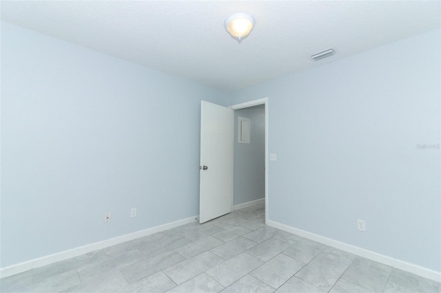 spare room with light tile patterned floors